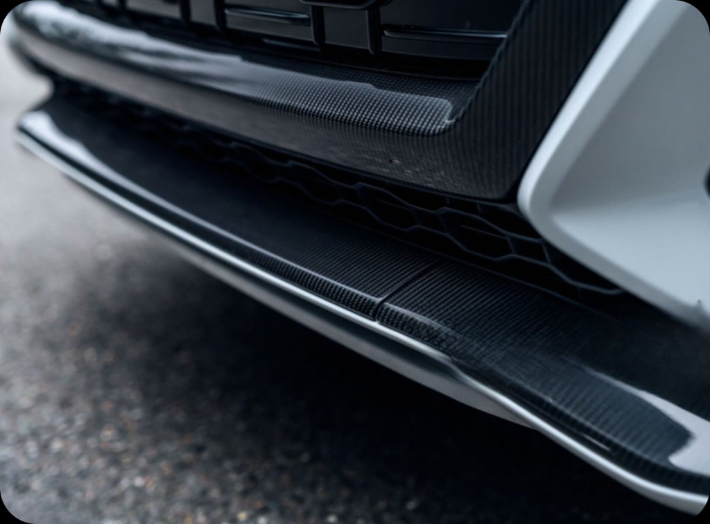 Close-up of a carbon fiber front splitter on a performance car